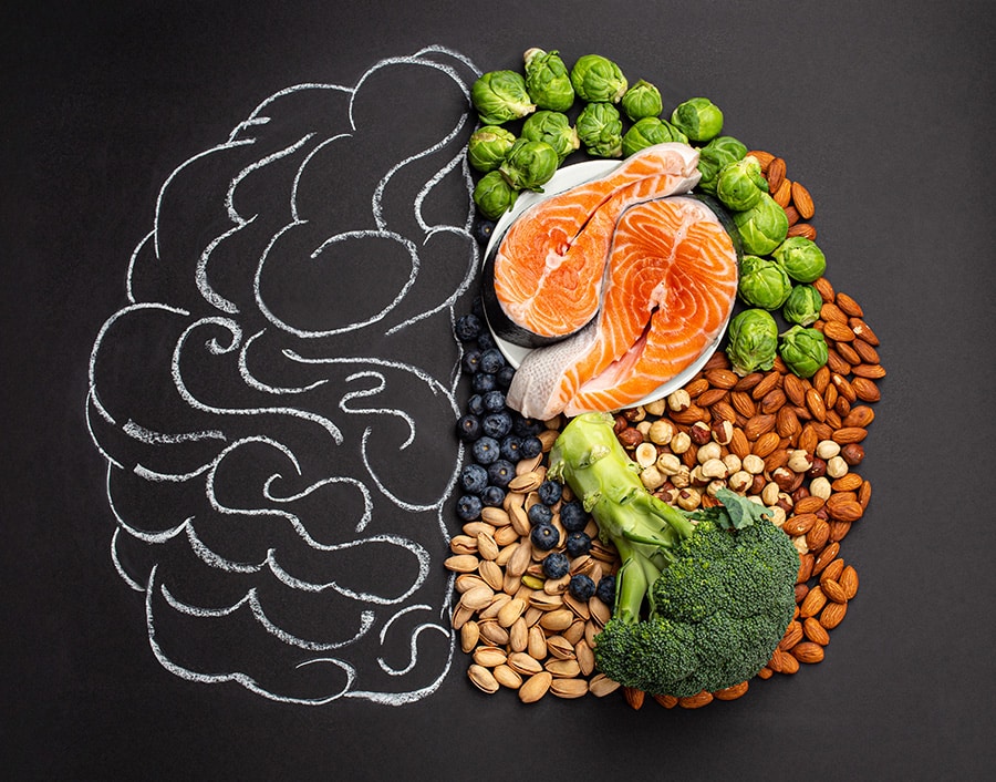 Fish and vegetables and nuts on a picture of a brain