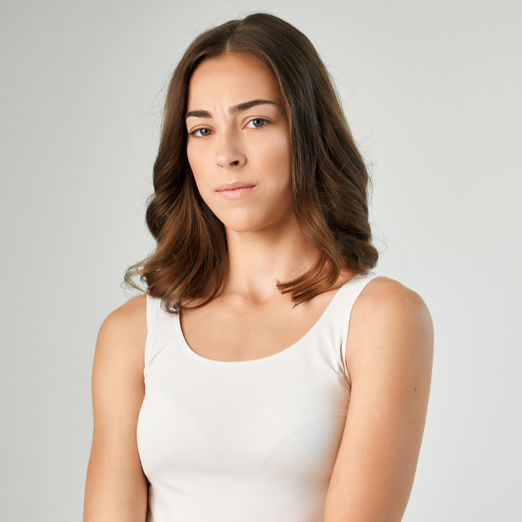 woman in white shirt stressed