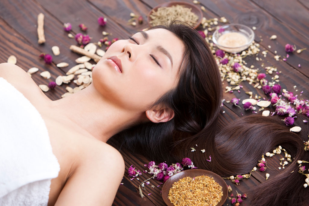beautiful young woman with herbal beauty treatment